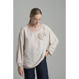 Beige oversize blouse with a decorative flower